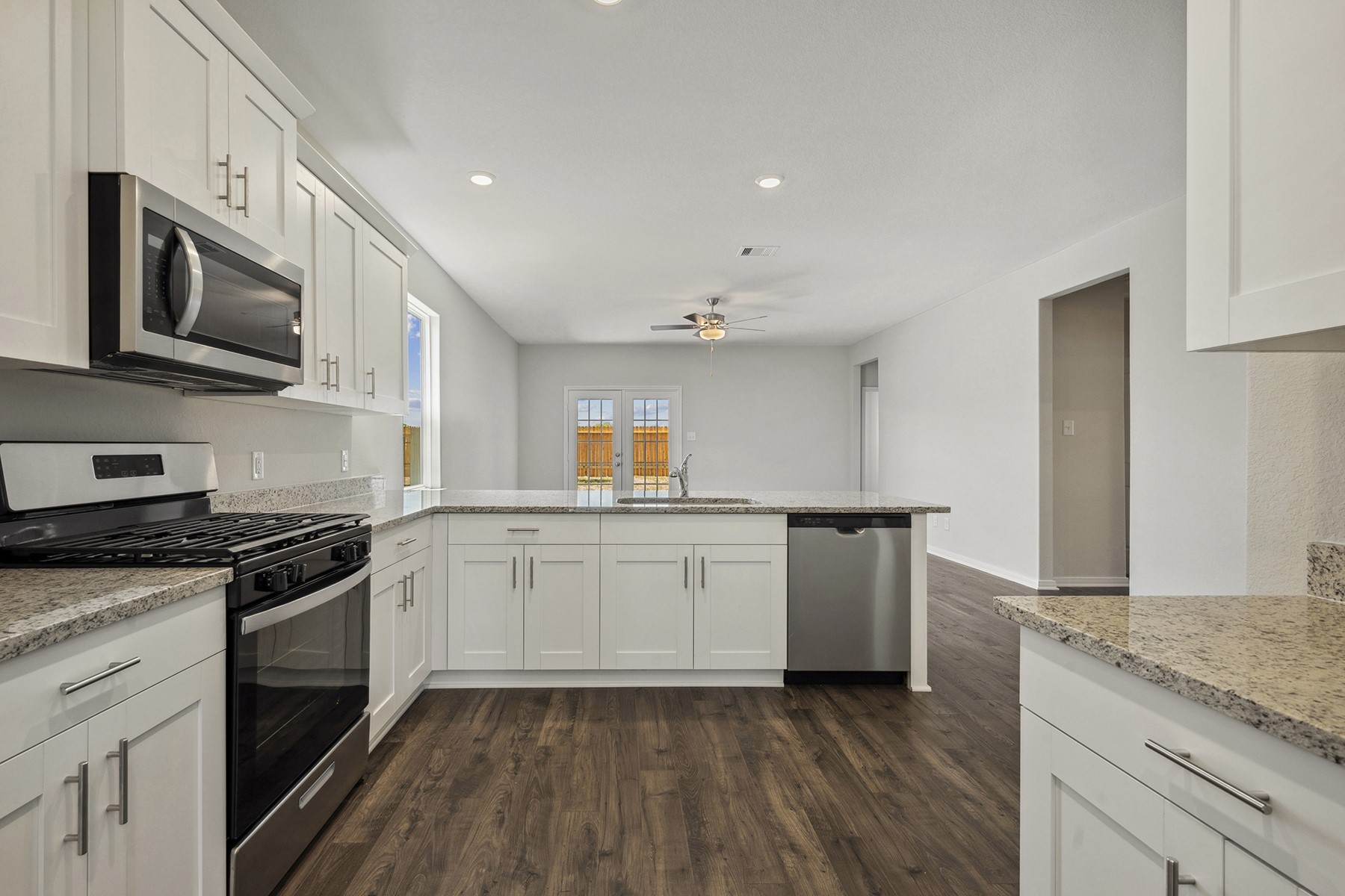 10422 Red Cardinal Drive Cleveland, TX 77328 - Photo 5 of 23 a kitchen with granite countertop cabinets stainless steel appliances and a sink