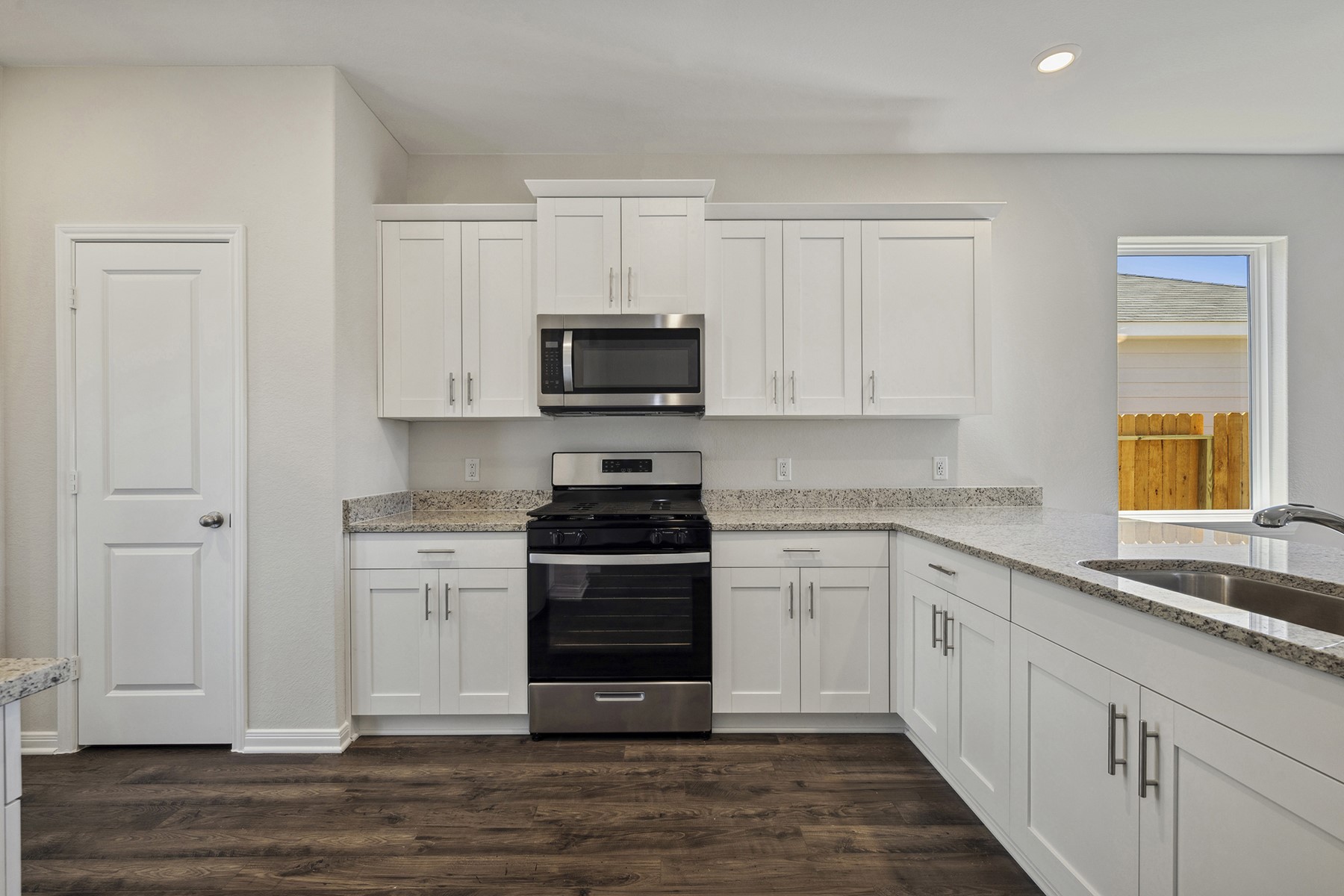 10422 Red Cardinal Drive Cleveland, TX 77328 - Photo 6 of 23 a kitchen with stainless steel appliances granite countertop a stove and a sink