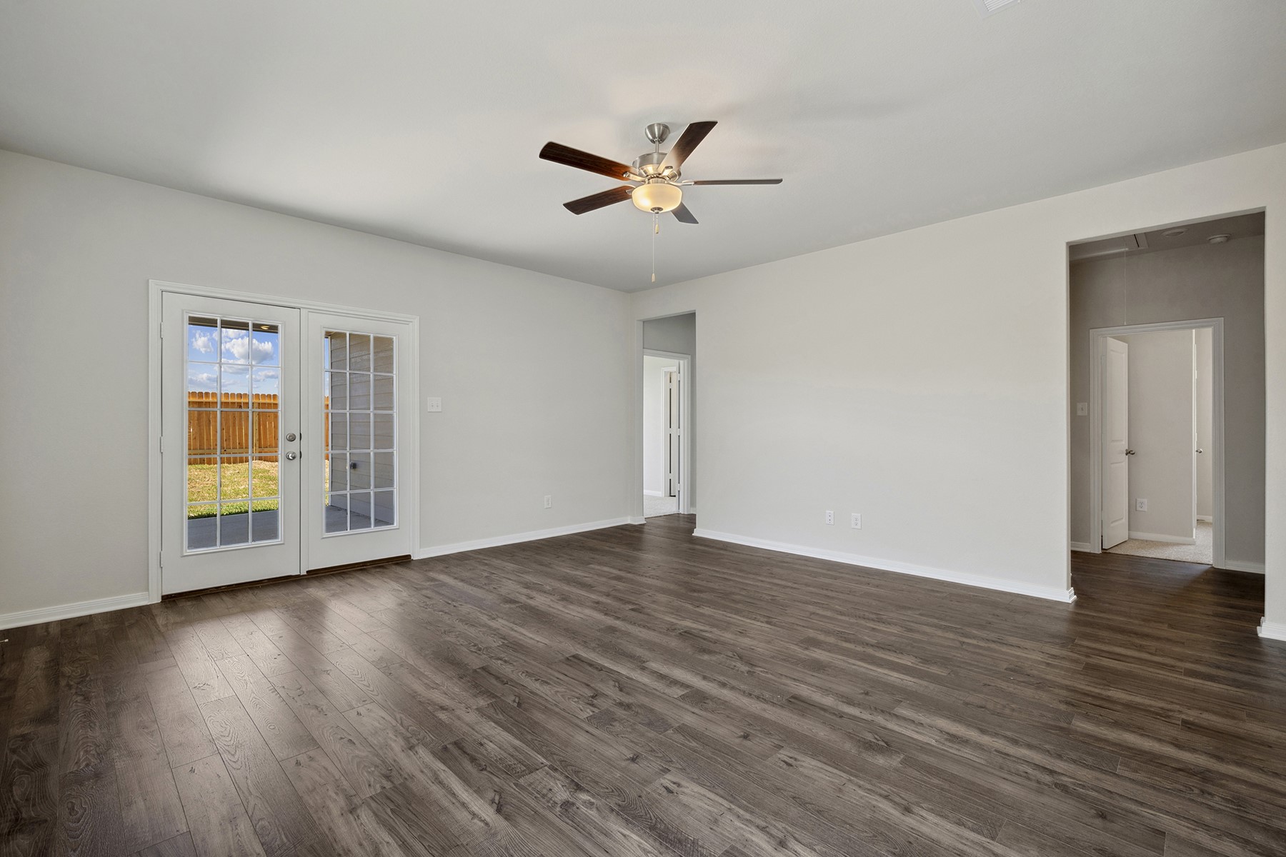 10422 Red Cardinal Drive Cleveland, TX 77328 - Photo 9 of 23 a view of an empty room with wooden floor and a window