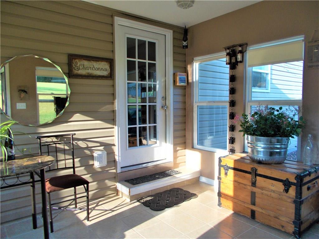 124 Currie Road Slippery Rock, PA 16057 - Photo 2 of 25 Entry. This quaint sun room provides a welcoming entry. It features ceramic tile flooring, overhead ceiling fan, and eight large windows with pull-down shades.