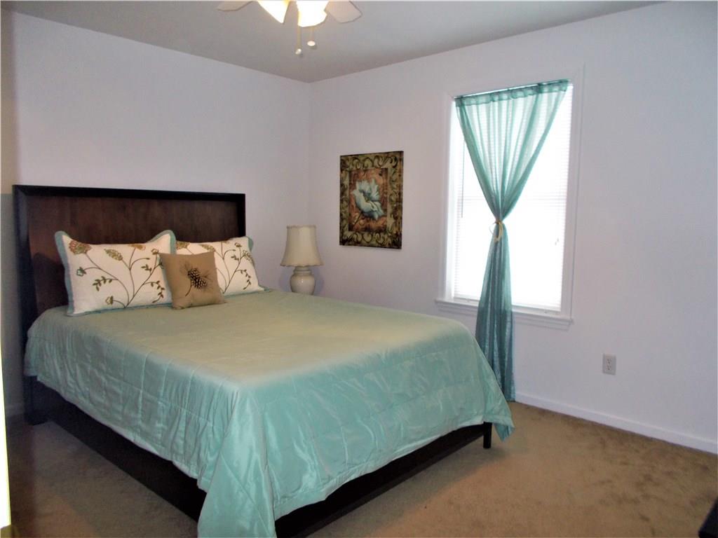 124 Currie Road Slippery Rock, PA 16057 - Photo 12 of 25 2nd Bedroom. Upper Level, 12x13. Featuring neutral colors, overhead ceiling fan, and walk-in closet. A 3rd (identical) bedroom is across the hall.