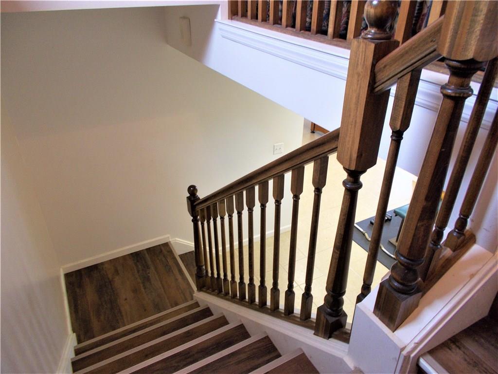 124 Currie Road Slippery Rock, PA 16057 - Photo 14 of 25 Stairwell from the family room to the lower level. Impressive French oak laminate flooring.