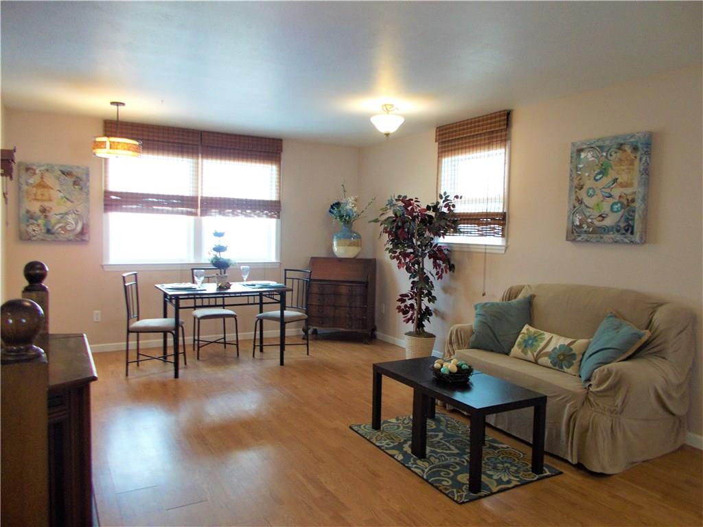 124 Currie Road Slippery Rock, PA 16057 - Photo 3 of 25 Living Room/Dining Room, Main Level, 12x26. Versatile large space with neutral colors and oak laminate flooring. Three large windows provide an abundance of natural light.