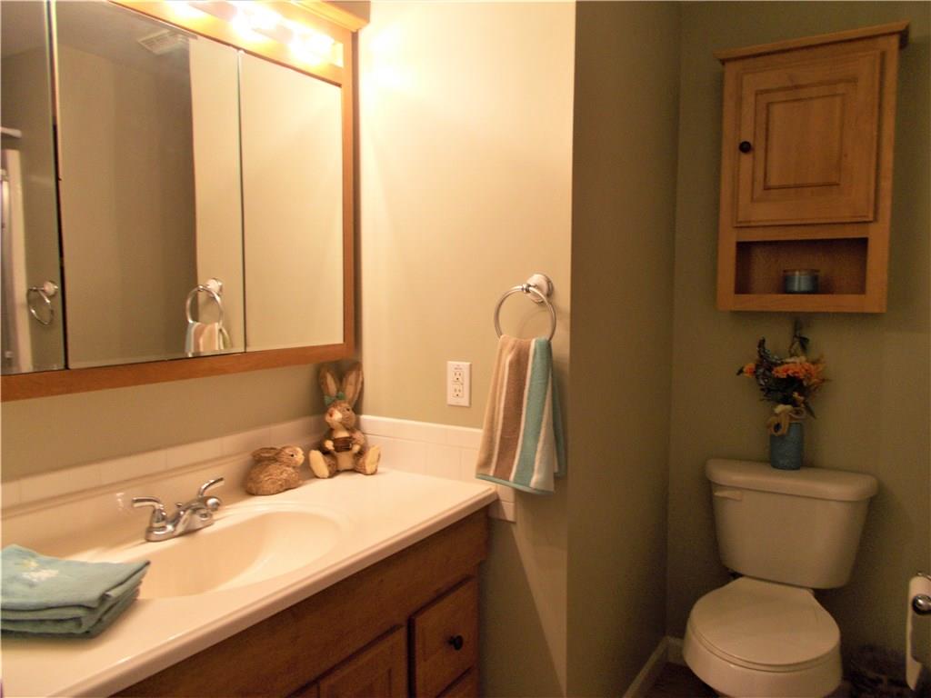 124 Currie Road Slippery Rock, PA 16057 - Photo 7 of 25 Master Bath, Main Level. Featuring honey oak vanity, oak flooring, and walk-in shower.