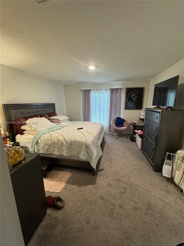 a living room with furniture and a mirror