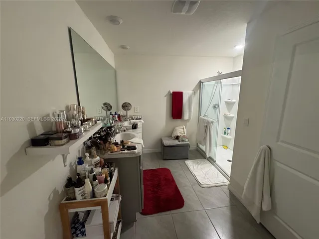 a bedroom with a bed and a large mirror