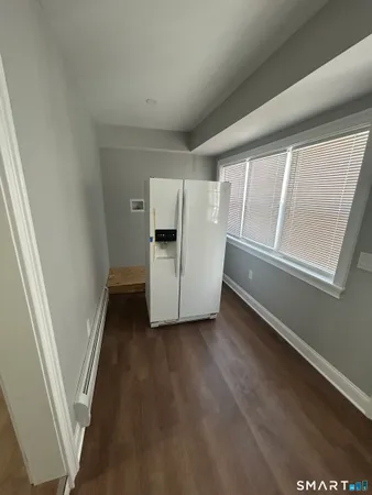 a view of a kitchen with wooden floor and electronic appliances