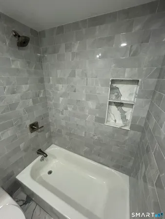 a bathroom with a double vanity sink toilet and shower