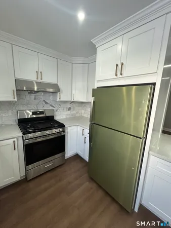 a kitchen with a refrigerator sink and stove