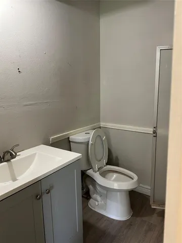 a white toilet sitting next to a bathroom sink