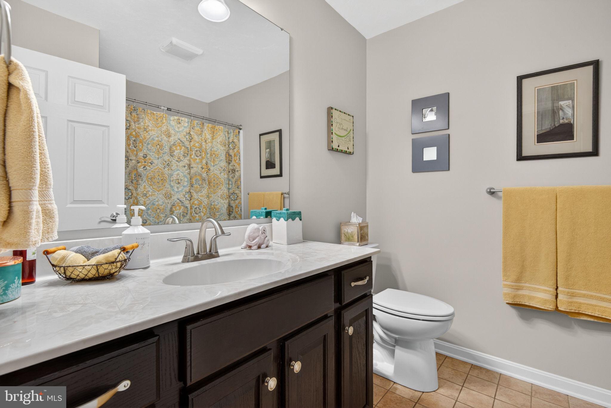 1332 Pleasant View Drive, Unit 75 Spring Grove, PA 17362 - Photo 17 of 26 a bathroom with a granite countertop sink a toilet and a mirror
