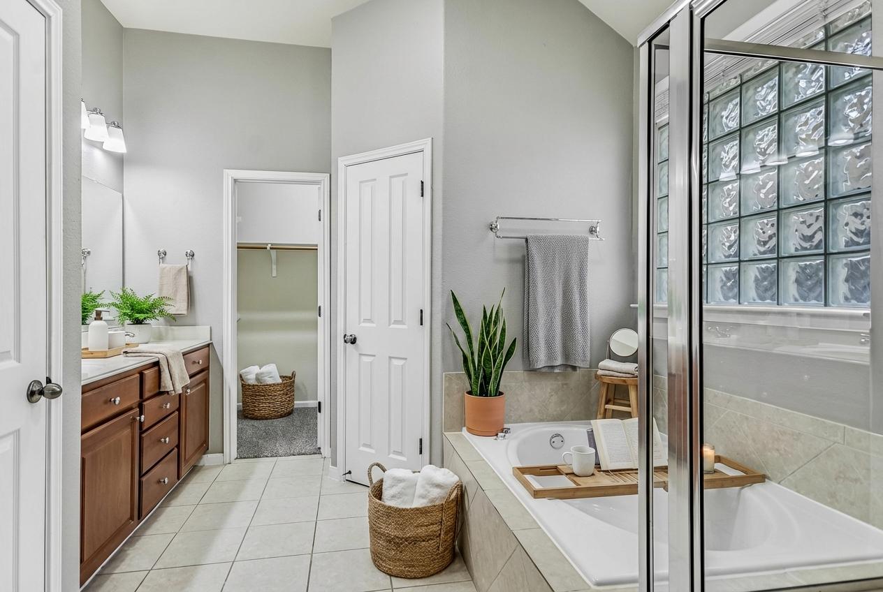 7416 Brecourt Manor Way Austin, TX 78739 - Photo 11 of 21 a room with a couch and a potted plant