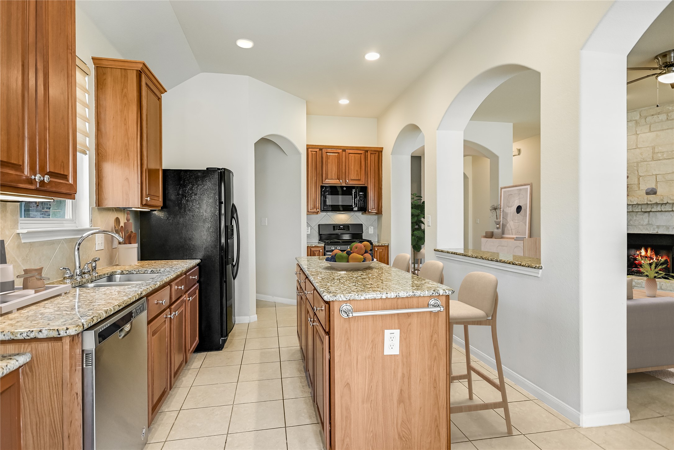 7416 Brecourt Manor Way Austin, TX 78739 - Photo 7 of 21 a kitchen with stainless steel appliances granite countertop a sink stove and refrigerator
