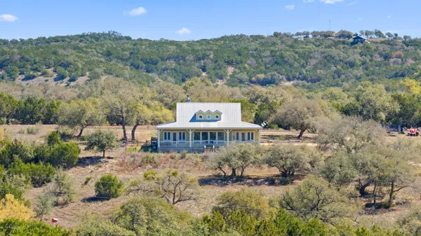 a view of a house with a yard and lake view