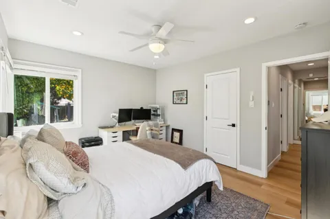 a bedroom with a bed and a chandelier