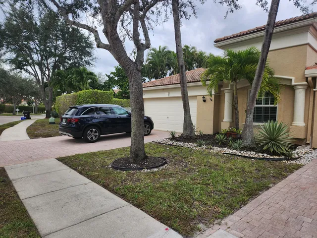 a view of a house with a sink in the patio next to a yard