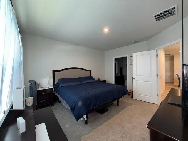 a bedroom with a bed and a couch