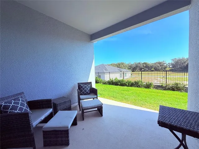 a view of a chairs in backyard of the house