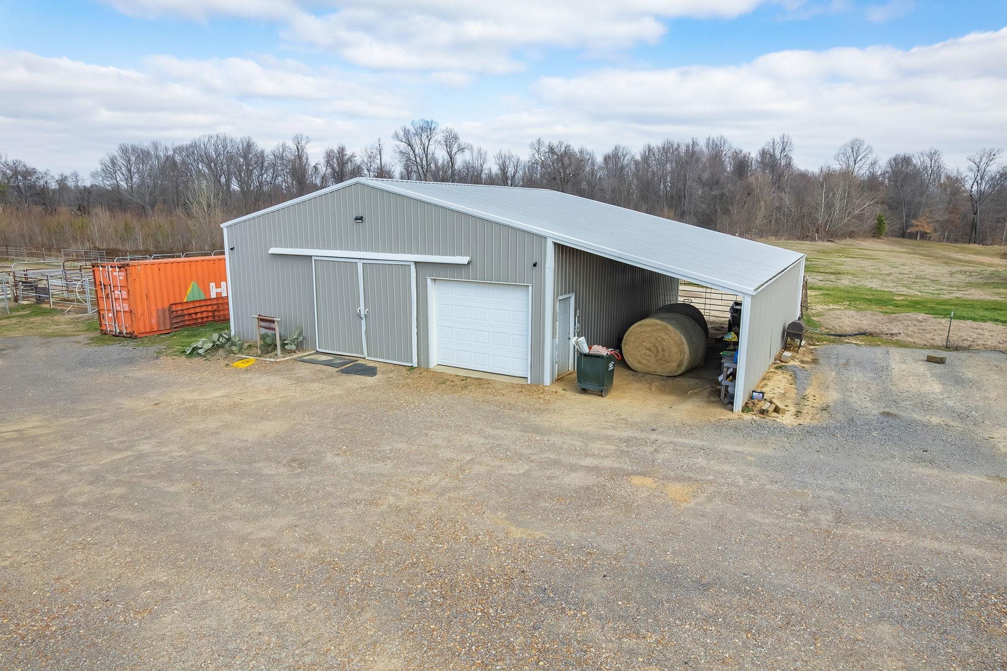 2656 Curve Woodville Road Ripley, TN 38063 - Photo 20 of 39 a front view of a house with a yard and garage