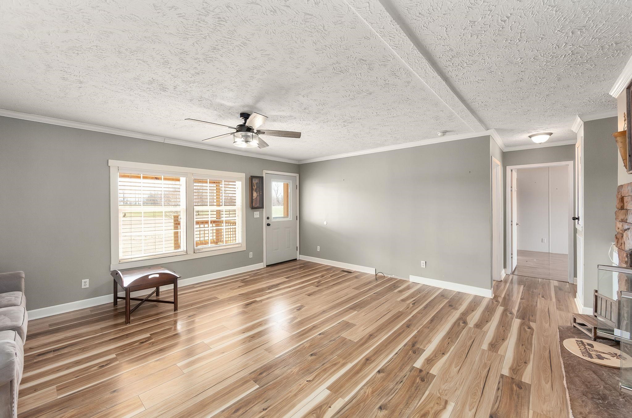 2656 Curve Woodville Road Ripley, TN 38063 - Photo 3 of 39 a view of a room with window a ceiling fan and wooden floor