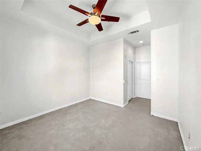 an empty room with closet and windows