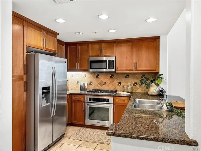 a kitchen with a refrigerator stove and microwave