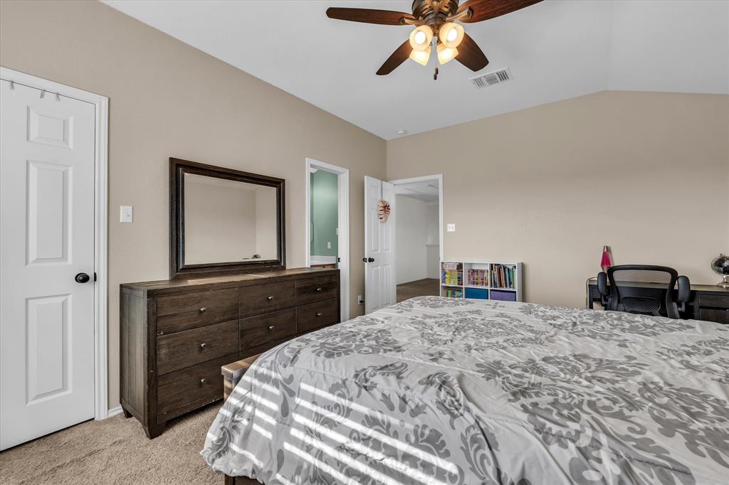 9453 Centennial Drive Waco, TX 76708 - Photo 26 of 37 a bedroom with a bed and a chandelier