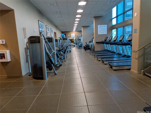 a room with gym equipment and a rug