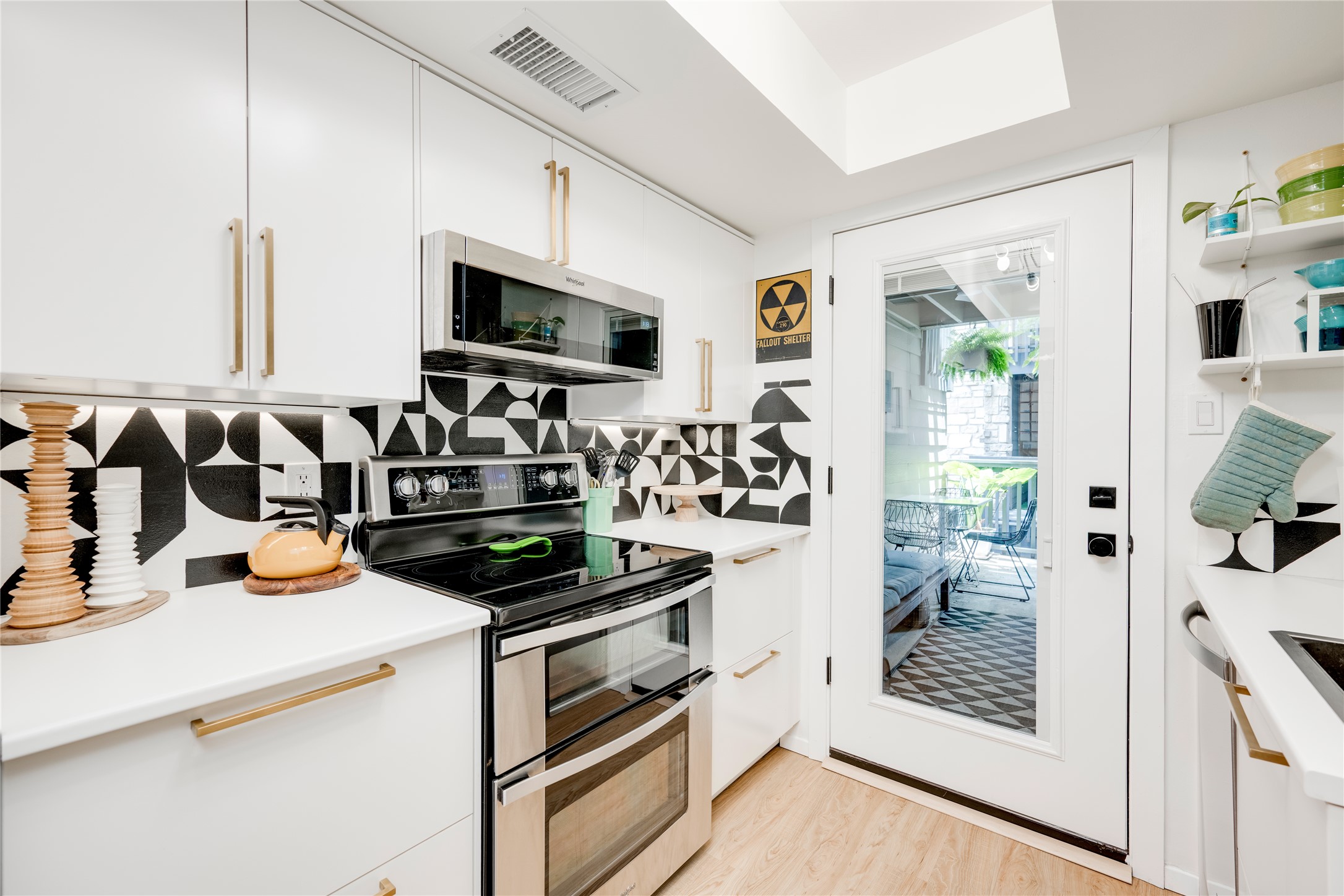 3627 Menchaca Road, Unit 214 Austin, TX 78704 - Photo 6 of 28 A well-appointed culinary space featuring sleek cabinetry and direct access to an outdoor oasis.