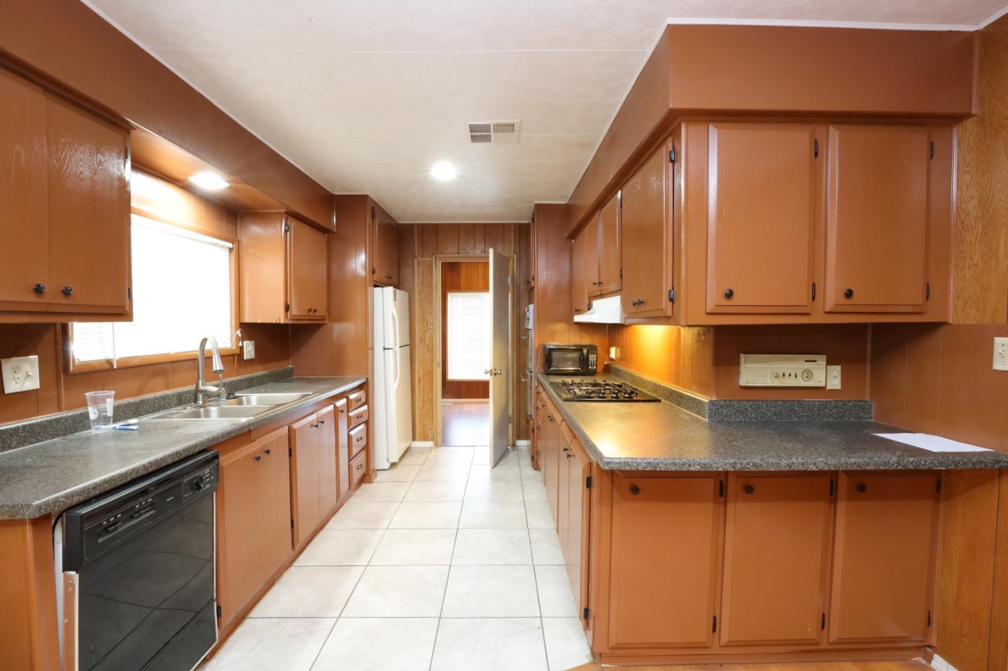 2151 Oakland Road, Unit 119 San Jose, CA 95131 - Photo 2 of 15 a kitchen with stainless steel appliances granite countertop a sink counter space cabinets and a large window