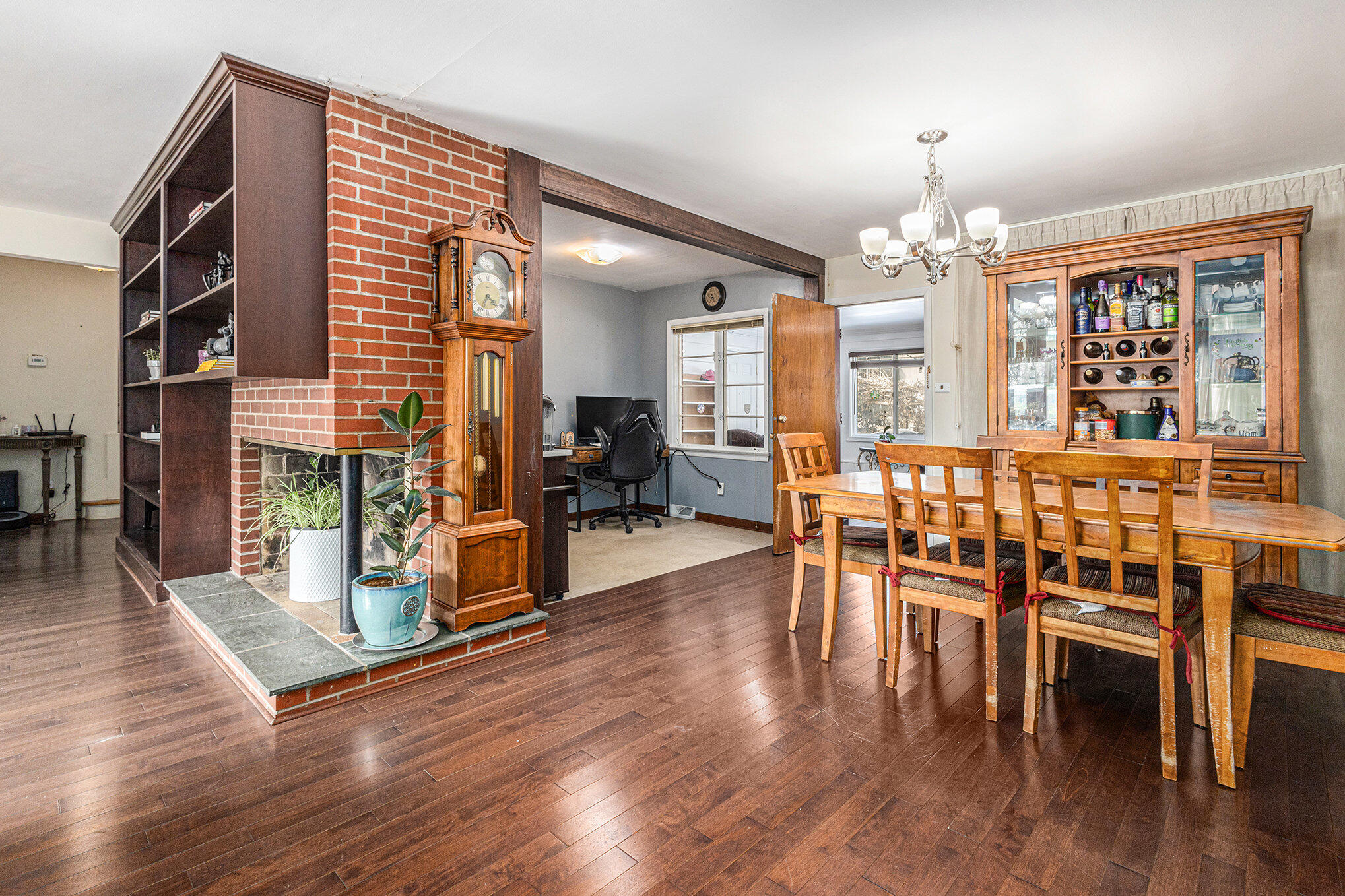 1511 Park Drive Munster, IN 46321 - Photo 12 of 23 a dining room with wooden floor a chandelier a glass table and chairs