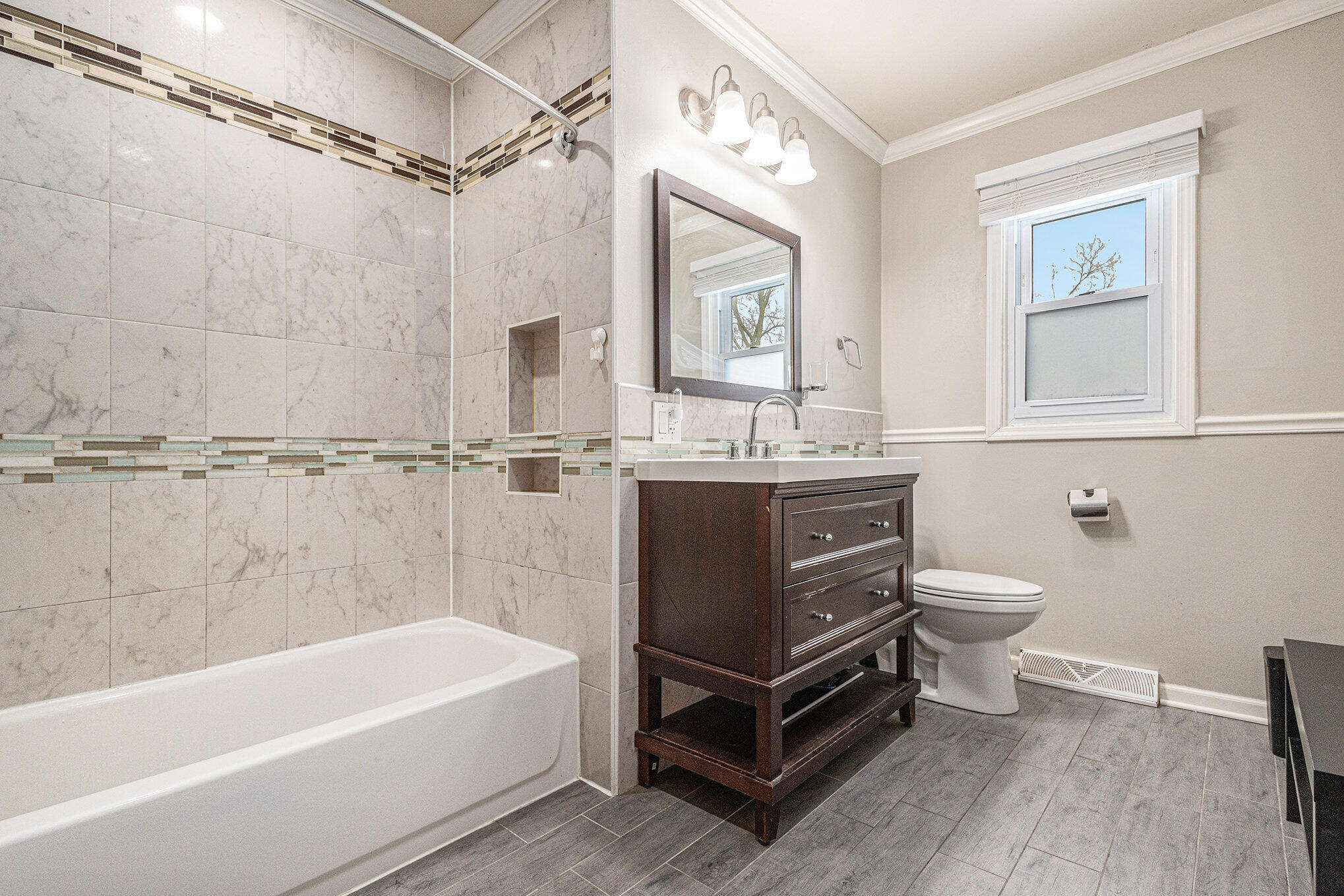 1511 Park Drive Munster, IN 46321 - Photo 14 of 23 a bathroom with a double vanity sink a toilet and a bathtub