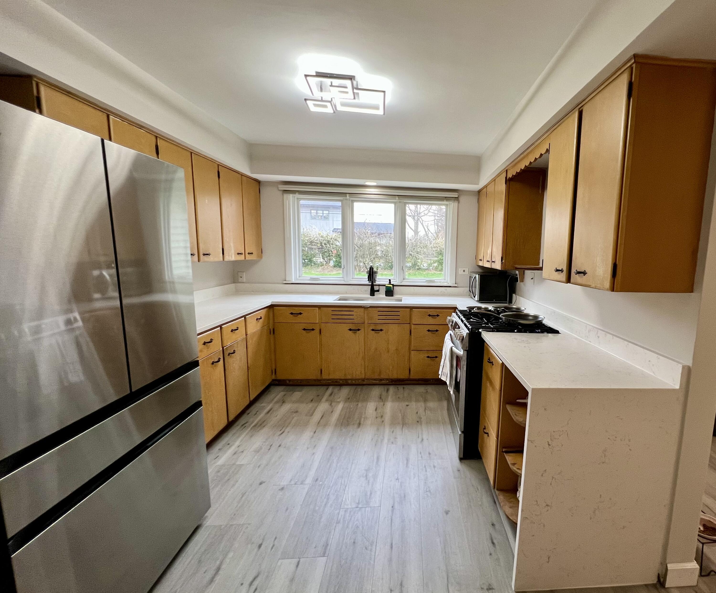 1511 Park Drive Munster, IN 46321 - Photo 6 of 23 a kitchen with granite countertop a sink a counter top space stainless steel appliances a window and a window