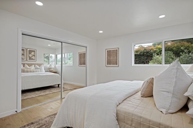 a bedroom with a large bed and a couch