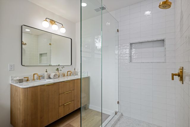 a bathroom with a double vanity sink mirror and