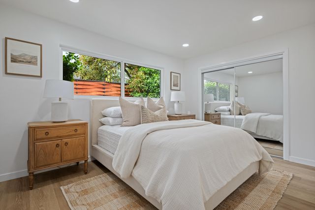 a bed room with a bed and a large window