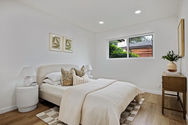 a bedroom with a bed and wooden floor
