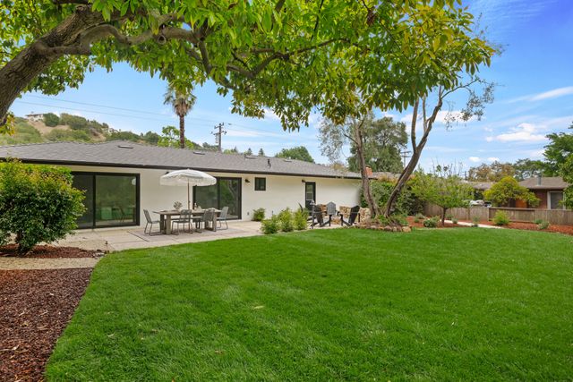 a front view of a house with table and chairs