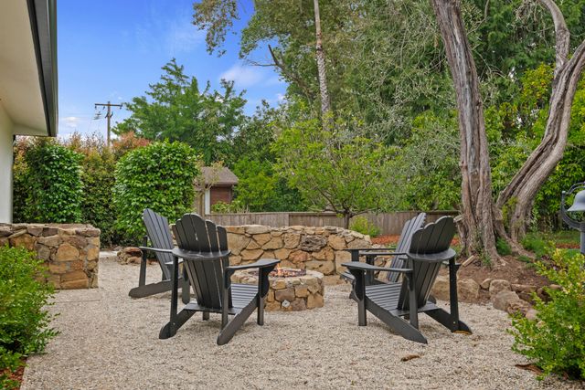 a view of a chairs and table in the back yard