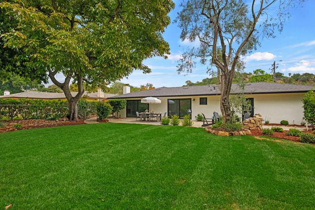 a front view of house with yard seating and green space