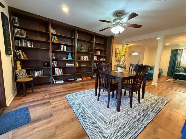 a dining room with furniture and wooden floor