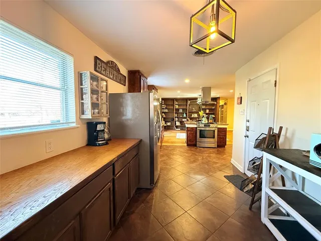 a kitchen with stainless steel appliances granite countertop a sink and cabinets