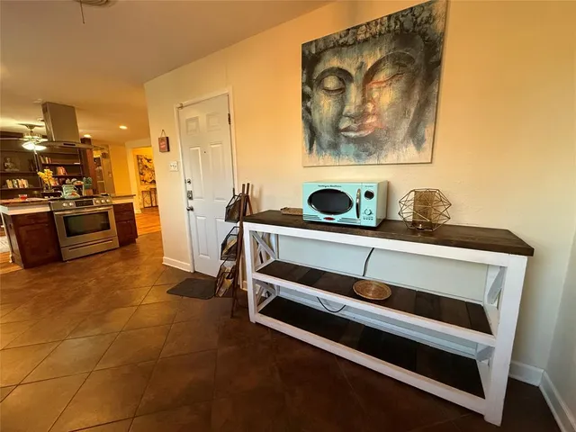 a living room with furniture and kitchen view