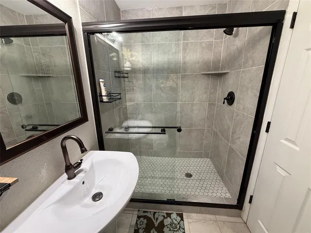 a bathroom with a sink and shower