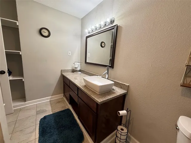 a bathroom with a sink a toilet and mirror