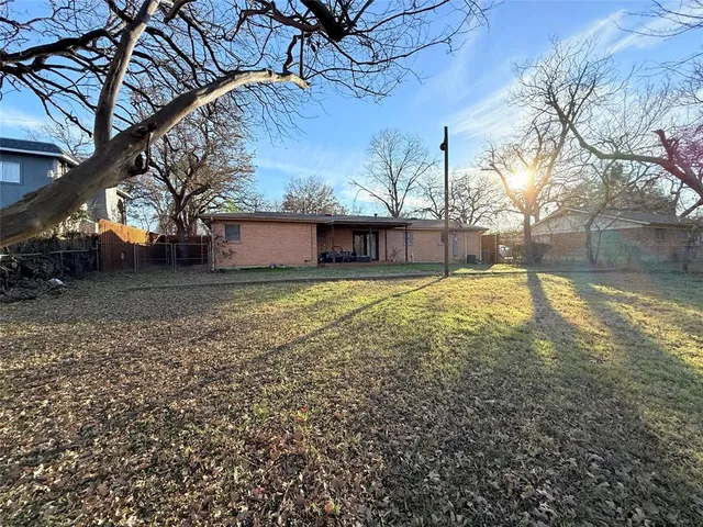 a view of a yard with a large tree