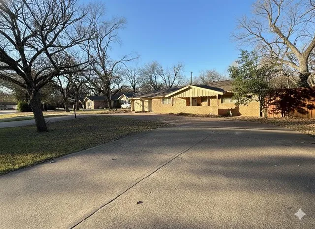 a street view with large trees