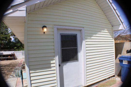 1043 South Downs Street Ridgecrest, CA 93555 - Photo 9 of 13 a view of a house with a door