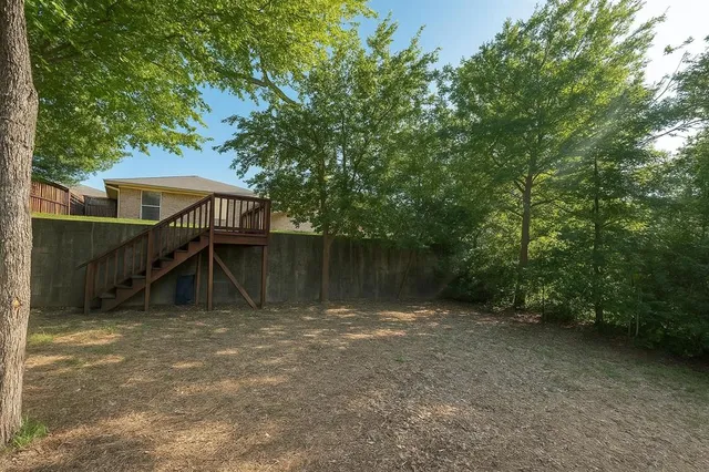 a backyard of a house with table and chairs