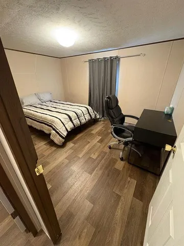 a bedroom with a bed and a mirror